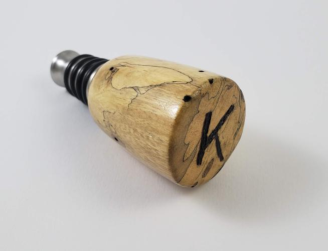 Turned spalted tamarind bottle stopper with a burned 
