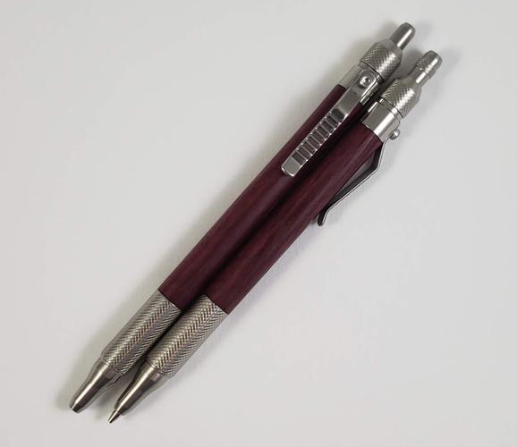 Pen and pencil set made with purple heart and a stainless steel hardware kit. The pen is slightly longer than the pencil to accommodate Pilot Precision refills.