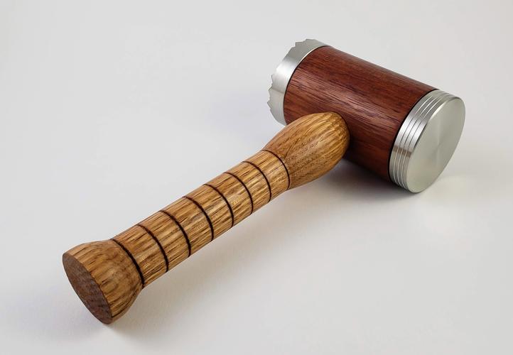 Turned oak and padauk meat tenderizer designed to look like a mallet.
